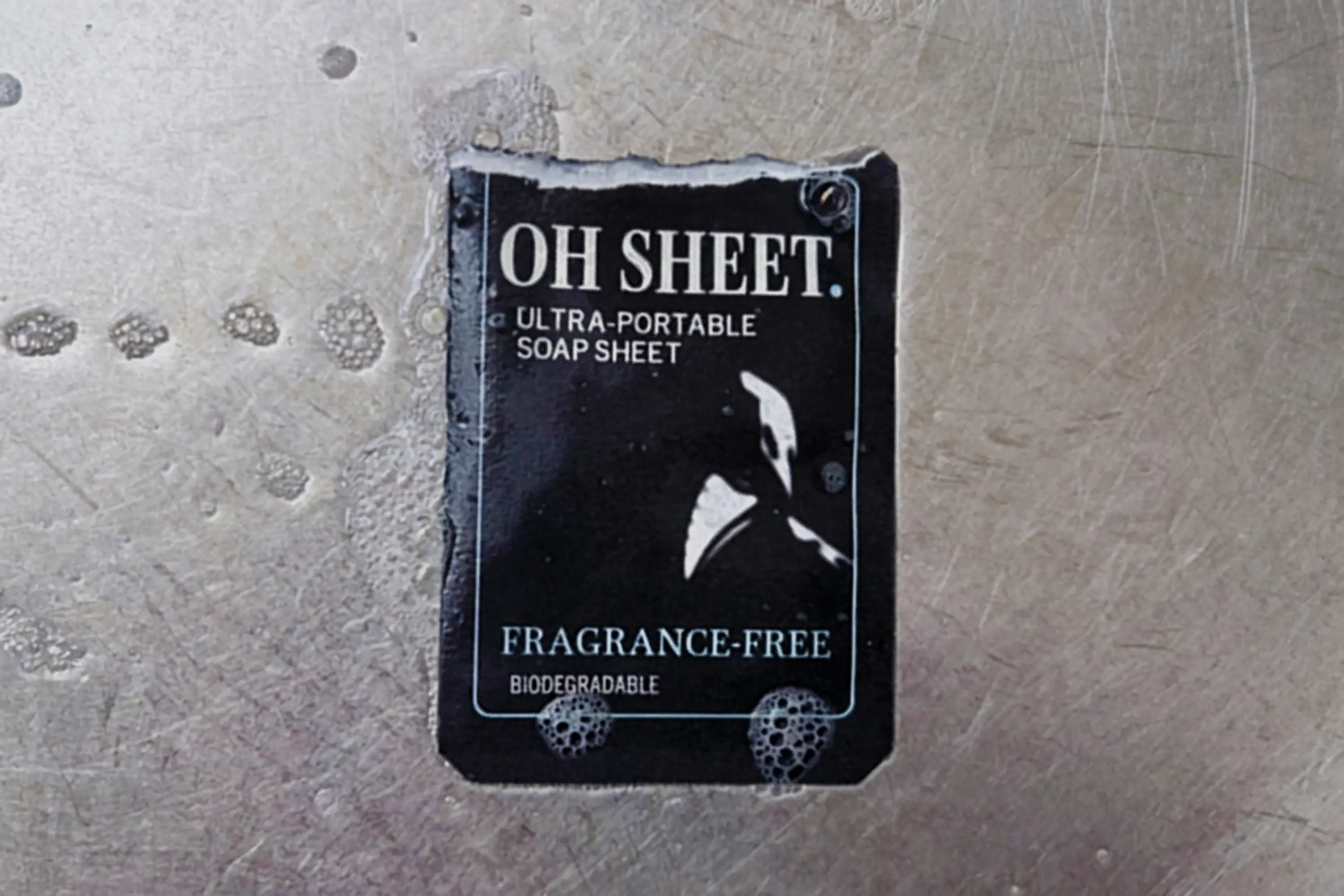 Individually wrapped sachet wet in sink with lather