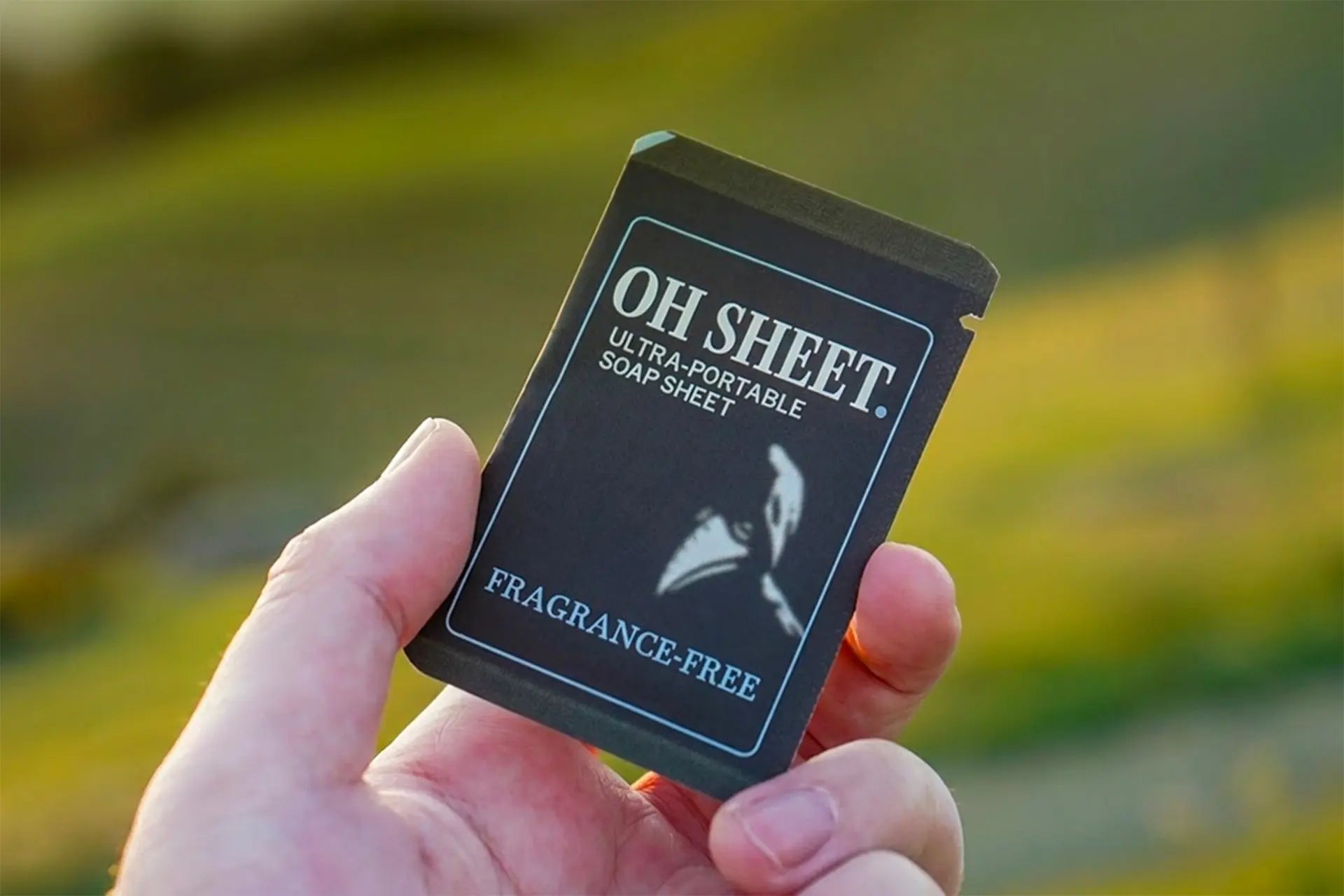 Portable travel Sized Paper Soap Sheet Held In Hand outdoors