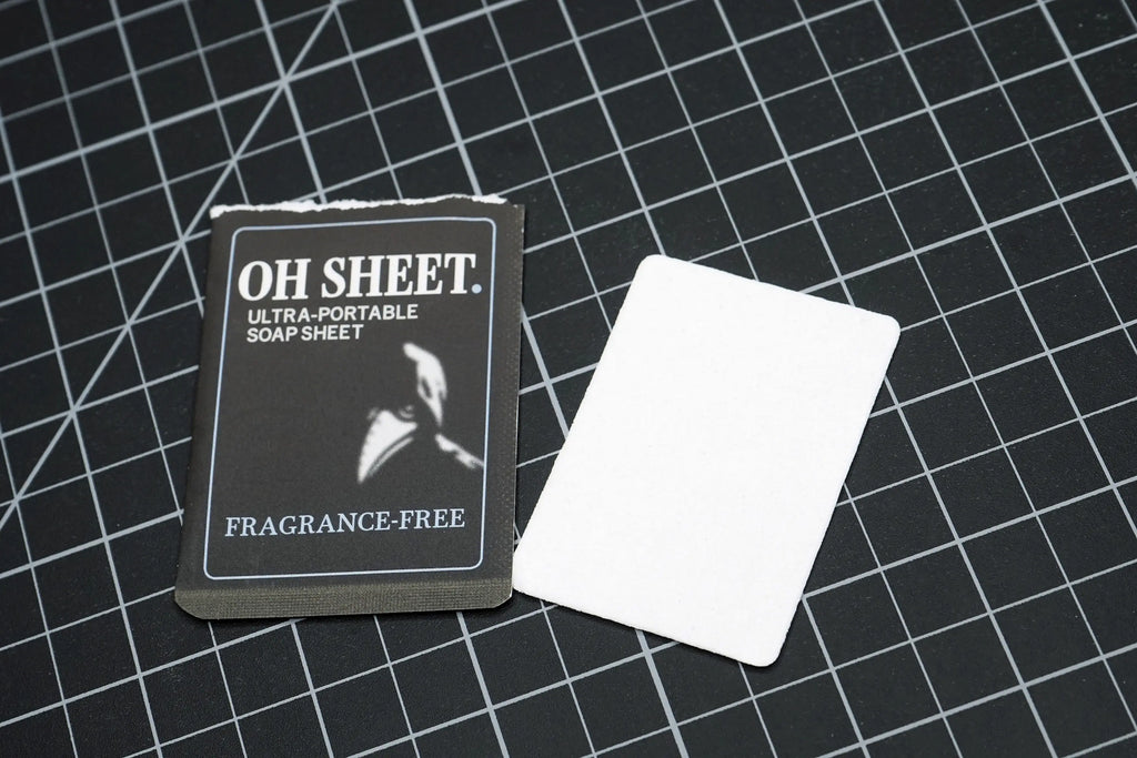 Single use fragrance free paper soap sheet beside sachet